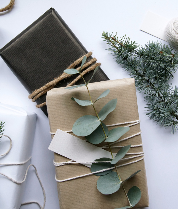 Christmas presents wrapped with foliage and string eucalyptus