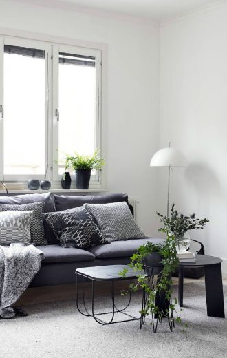 living room showing two coffee tables styled in a minimalist, Scandinavian interior design