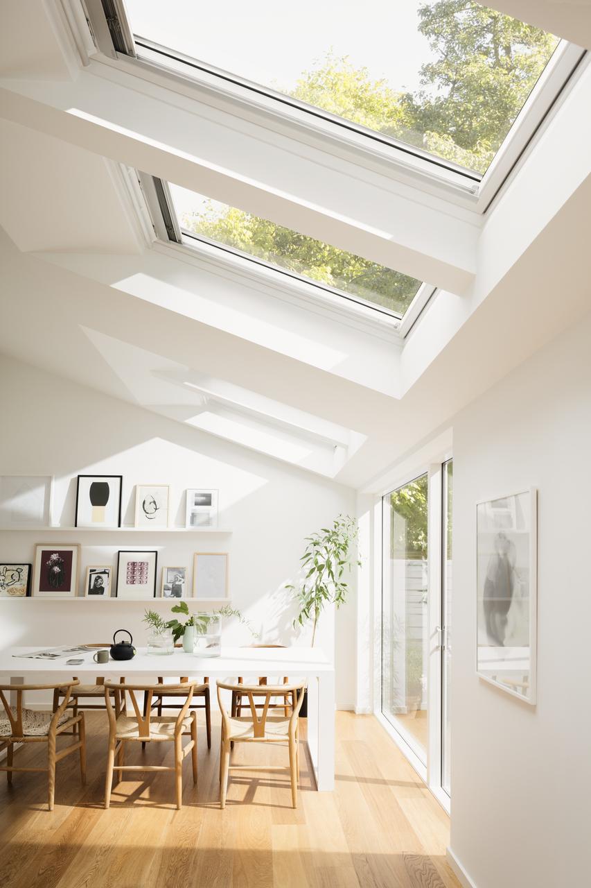 bright dining room in white with roof windows