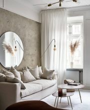 Beige toned living room with exposed walls and linen sofa