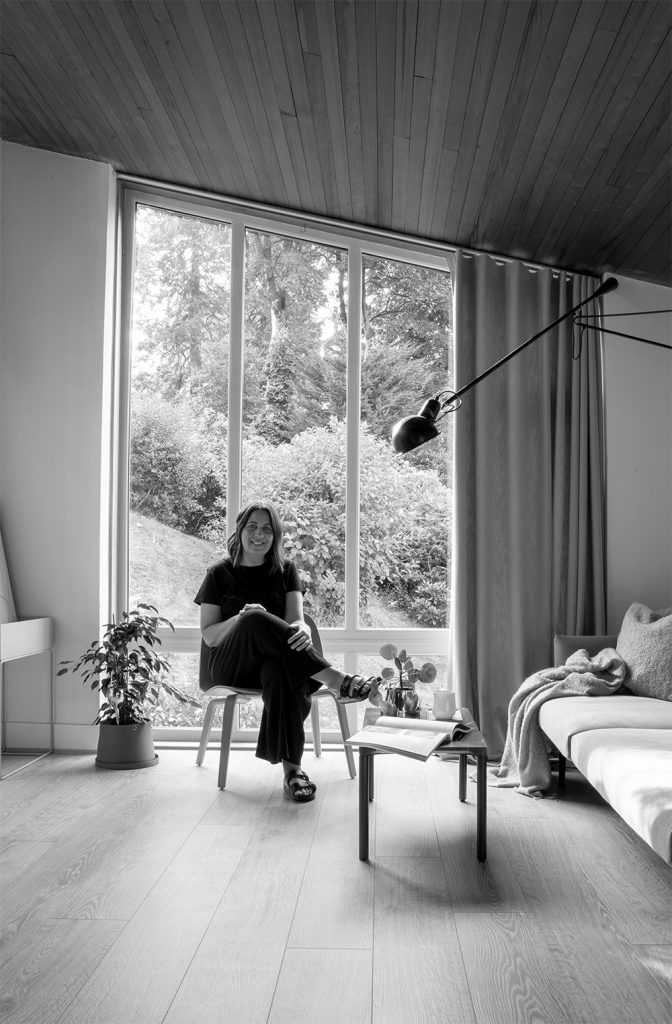 Hege Morris sitting in her minimalist Nordic design inspired home. She specialises in branding, and Pinterest marketing and management