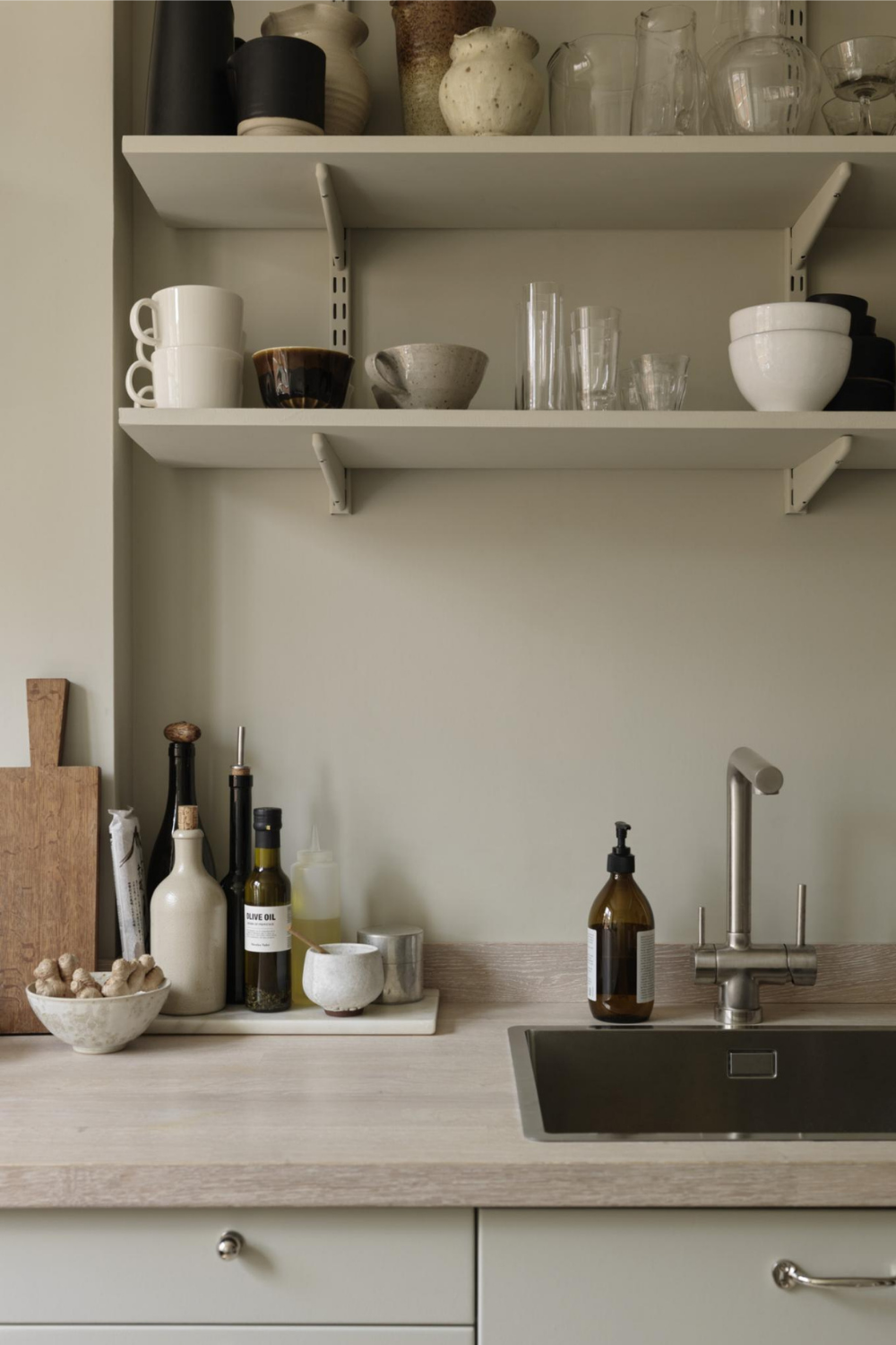 beige kitchen with open shelves and ceramics on display