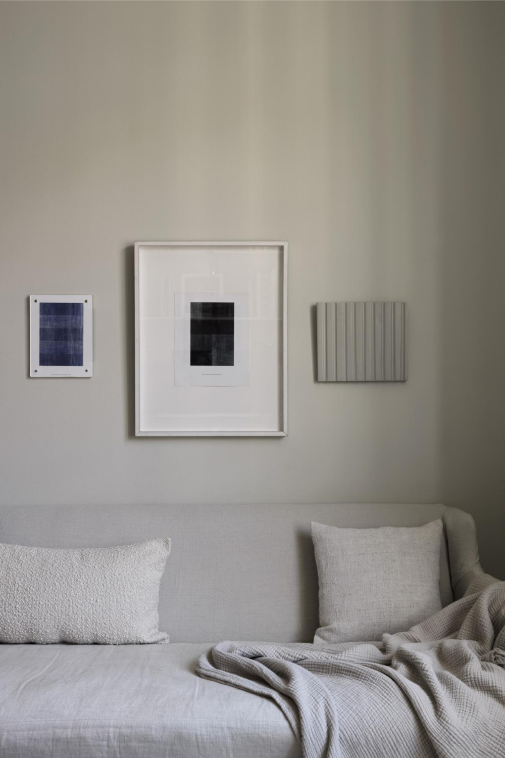 minimal gallery wall idea for a beige living room using neutral art prints and frames