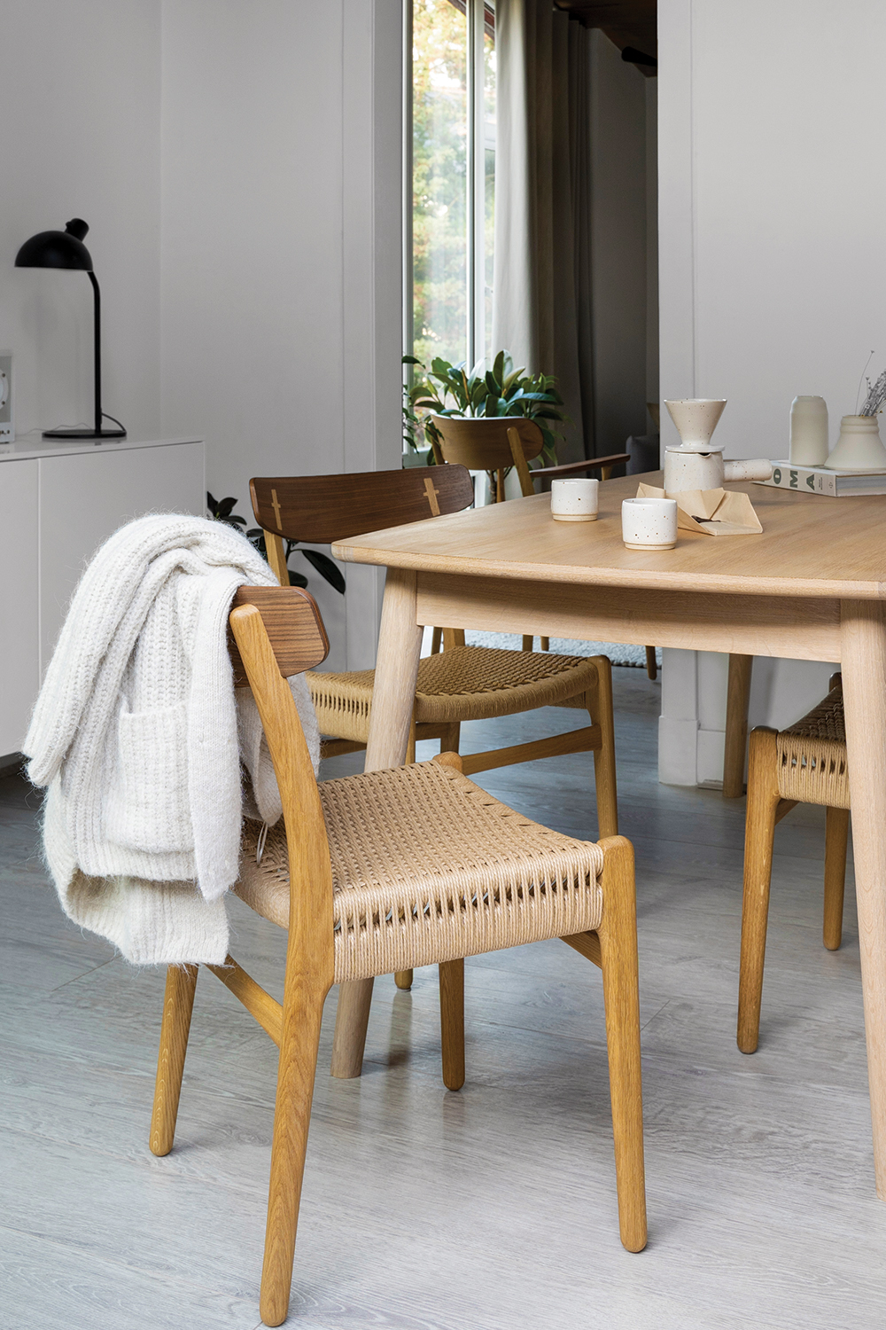bright, airy modernist dining room with Carl Hansen chairs in natural, sustainable materials