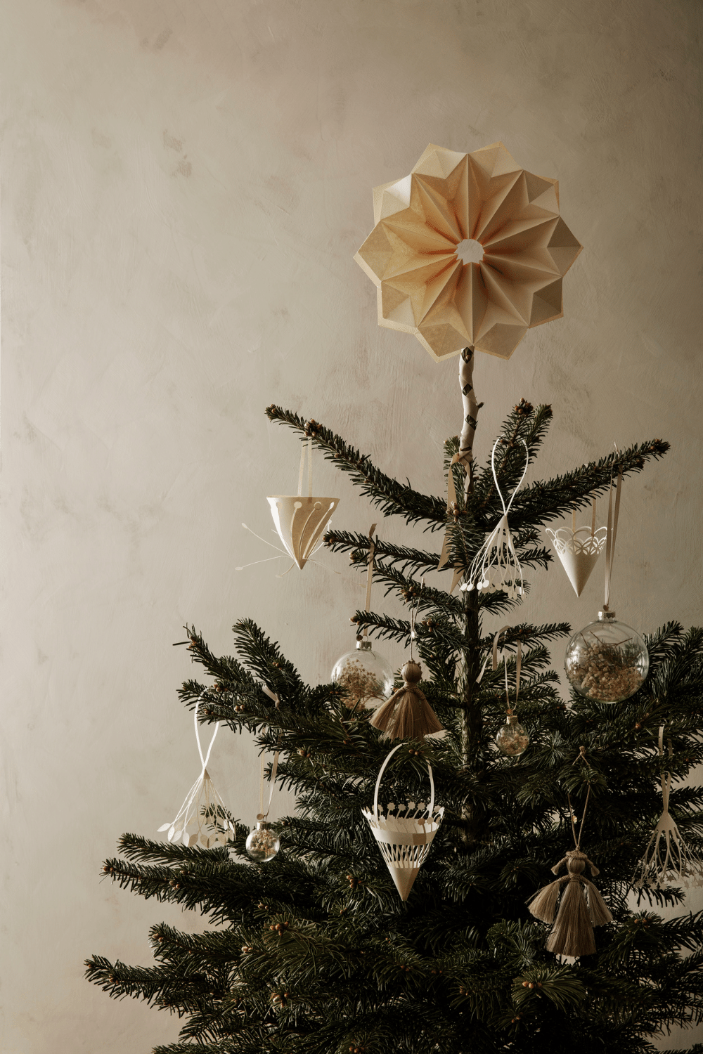 Christmas tree with paper decorations in Scandinavian style